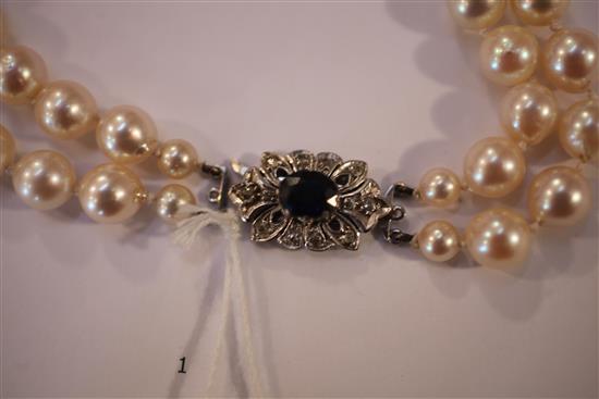 A double strand cultured pearl necklace with white gold, sapphire and diamond set clasp, 19.5in.